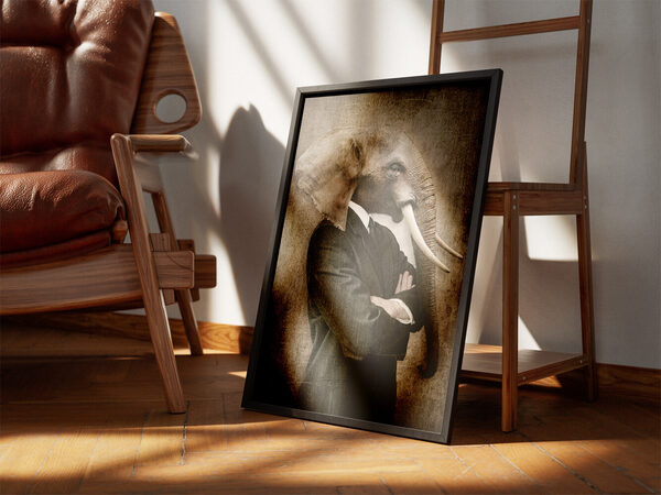 A surreal image of an elephant head on a man's body wearing a black suit and white shirt, arms crossed, against a textured background.
