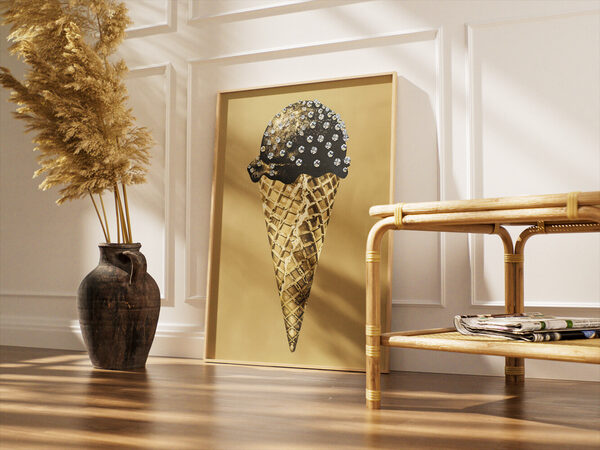 Stylized ice cream cone with a black scoop adorned with clear gems and gold glitter, on a gold waffle cone.