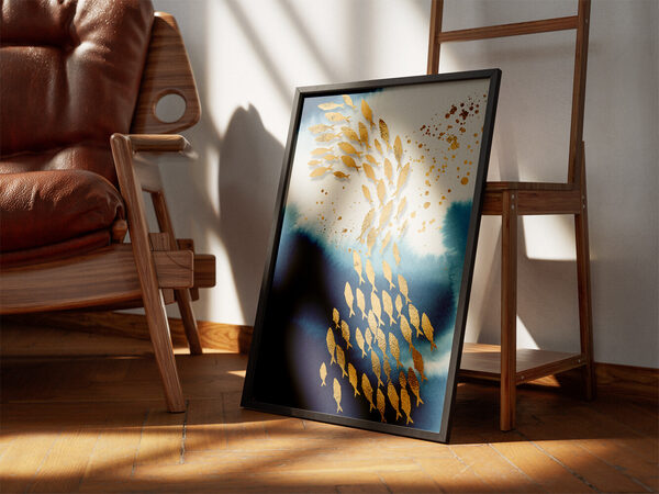 Abstract art with a school of textured golden fish swimming through deep blue watercolor washes and white space.